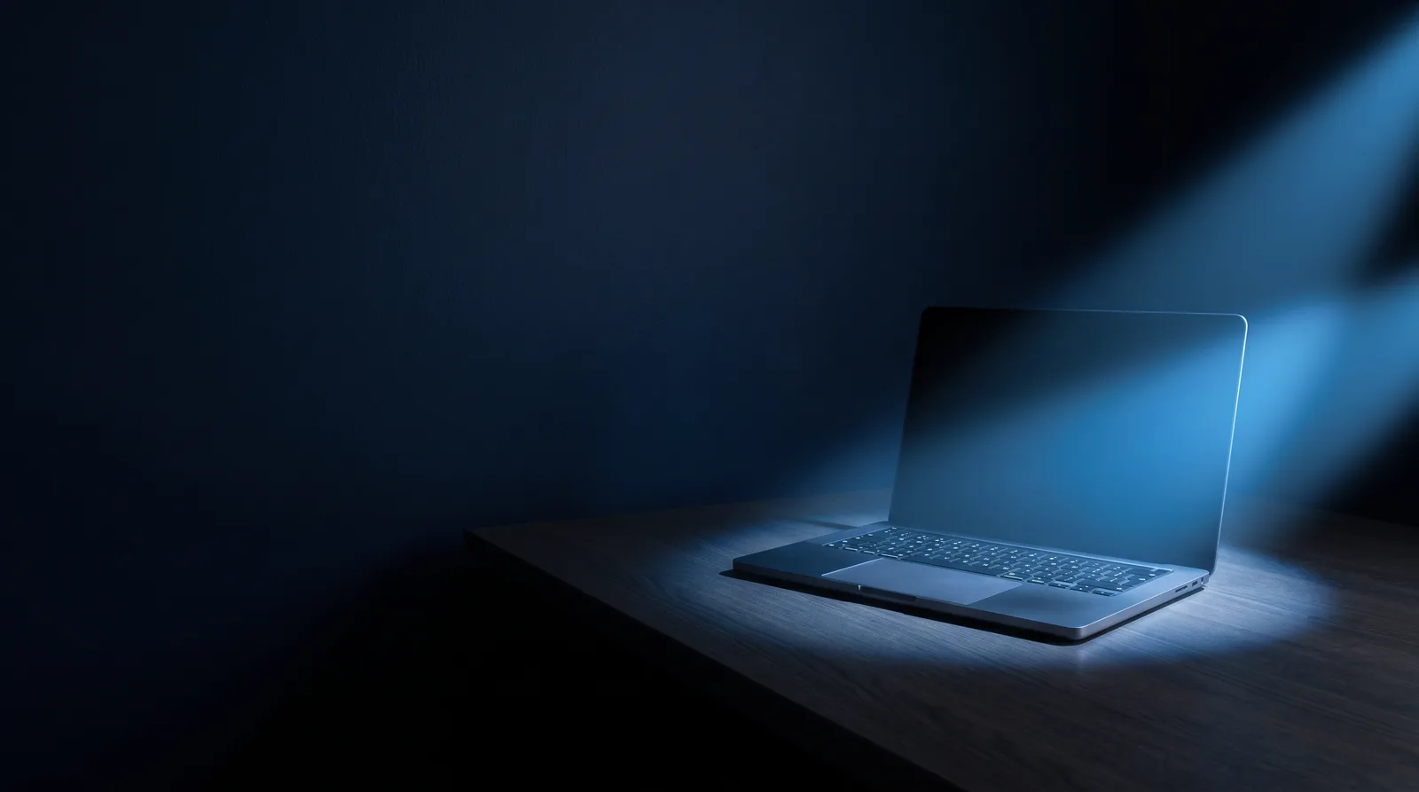 A laptop screen on a dark desk catching several soft beams of blue light, illustrating how an AI aggregator pulls many models into one interface.